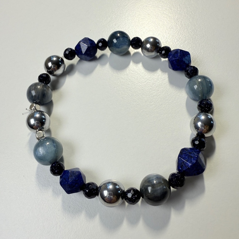 Deep blue bracelet with cat’s eye, metallic beads, and faceted dark crystals.